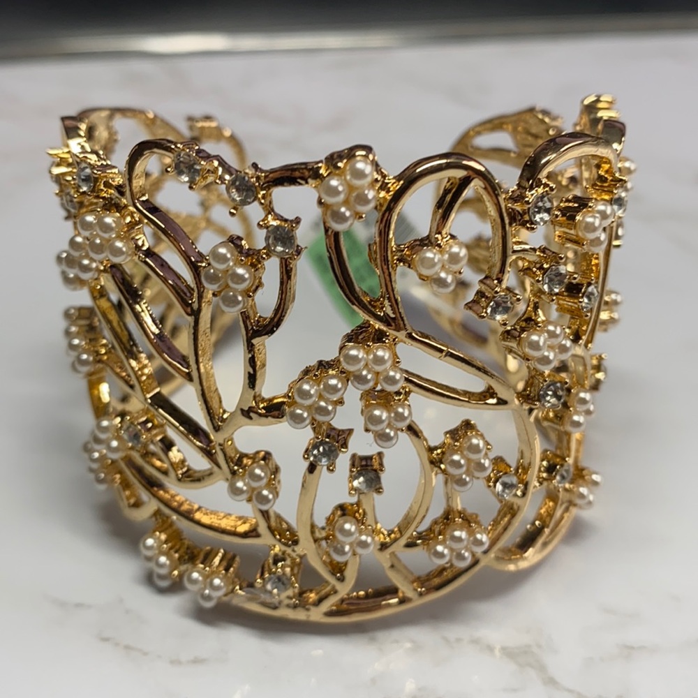 Gold tone cuff bracelet accented with pearls and crystal stones